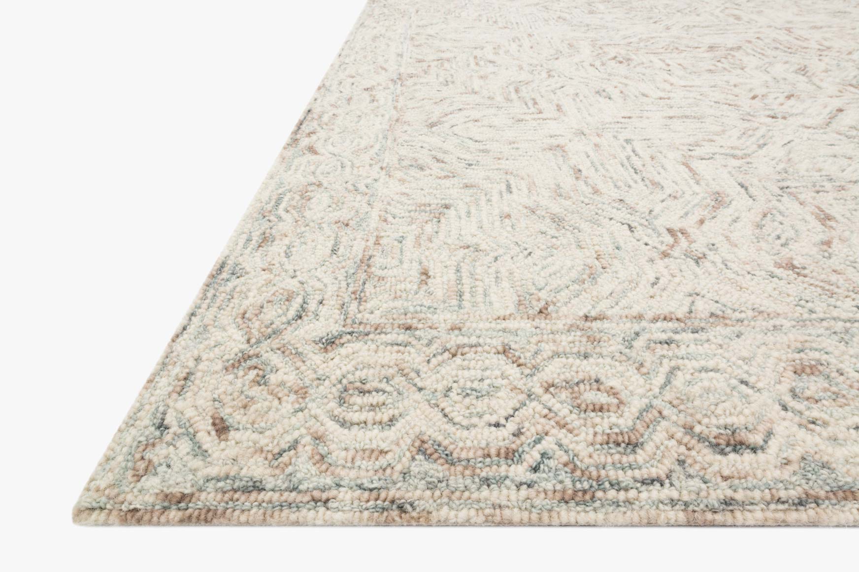 Light beige geometric rug corner with short loop pile and stitched border