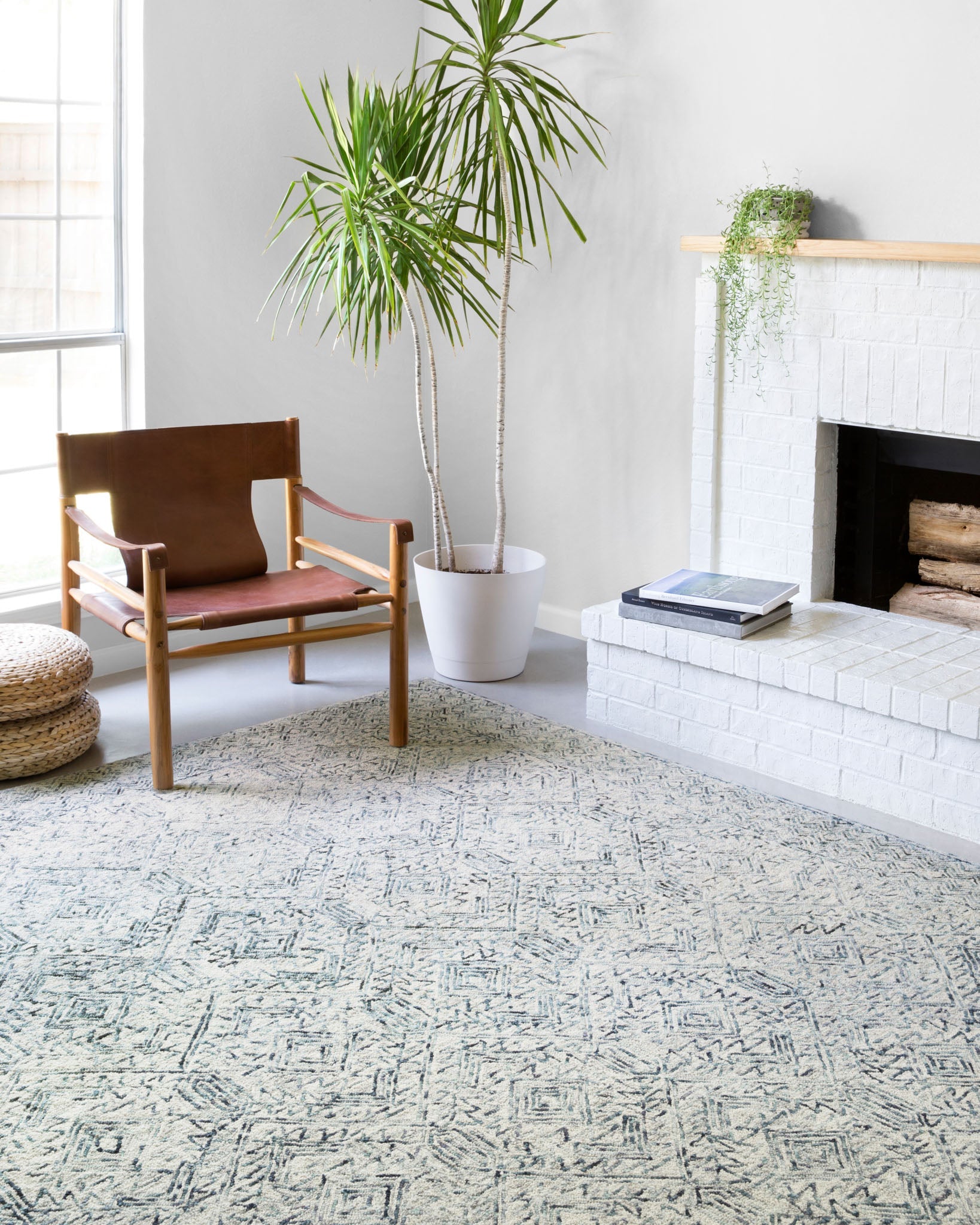 Contemporary hand-tufted rug with geometric pattern in bluestone and ivory, corner view