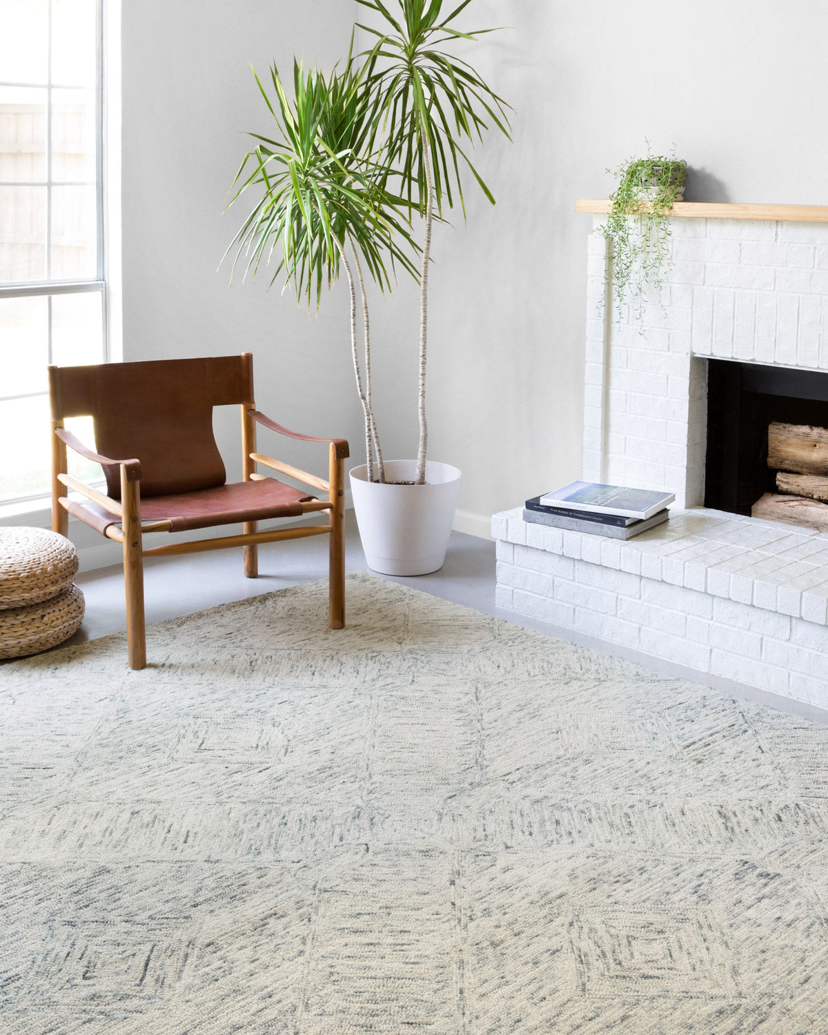Sky-blue hand-tufted area rug with distressed geometric pattern and textured pile