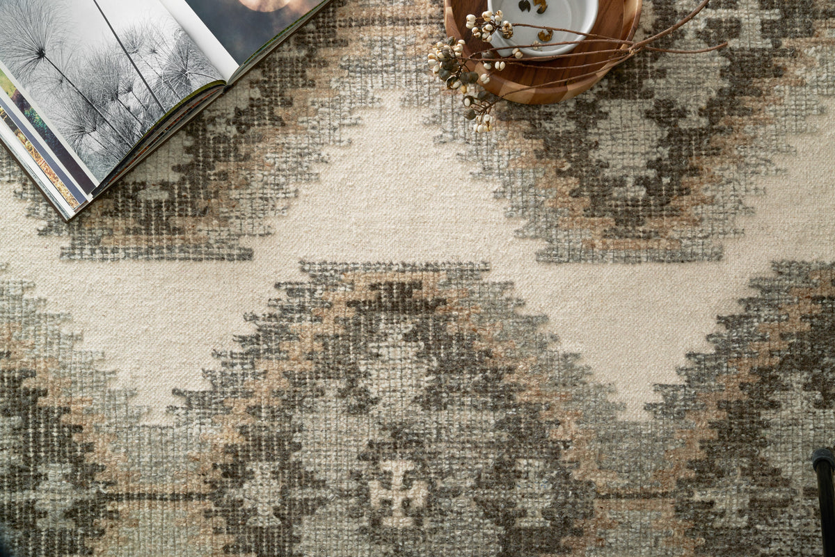 Hand-woven ivory rug texture with layered gray and camel geometric pattern