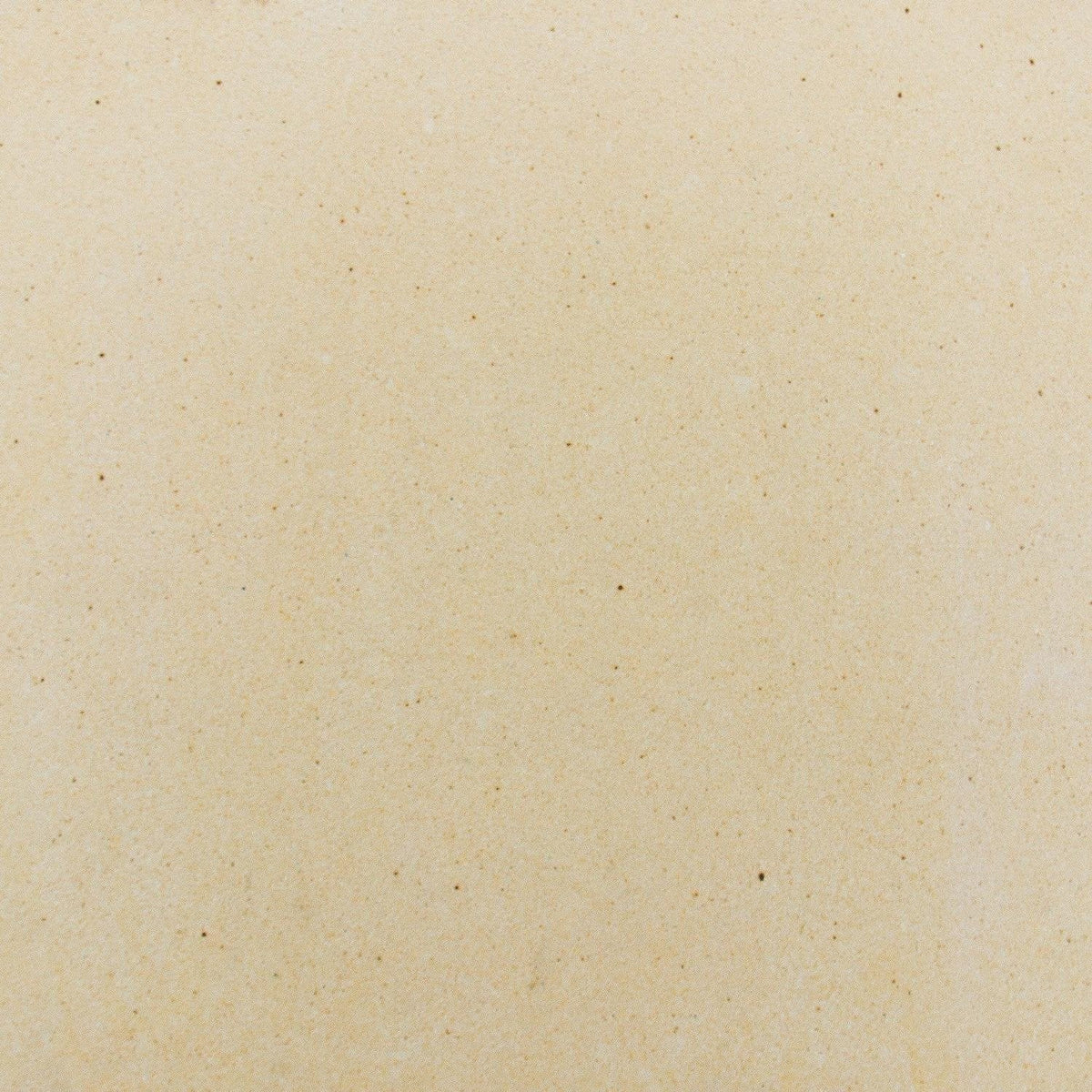 Light beige speckled ceramic pizza stone surface texture