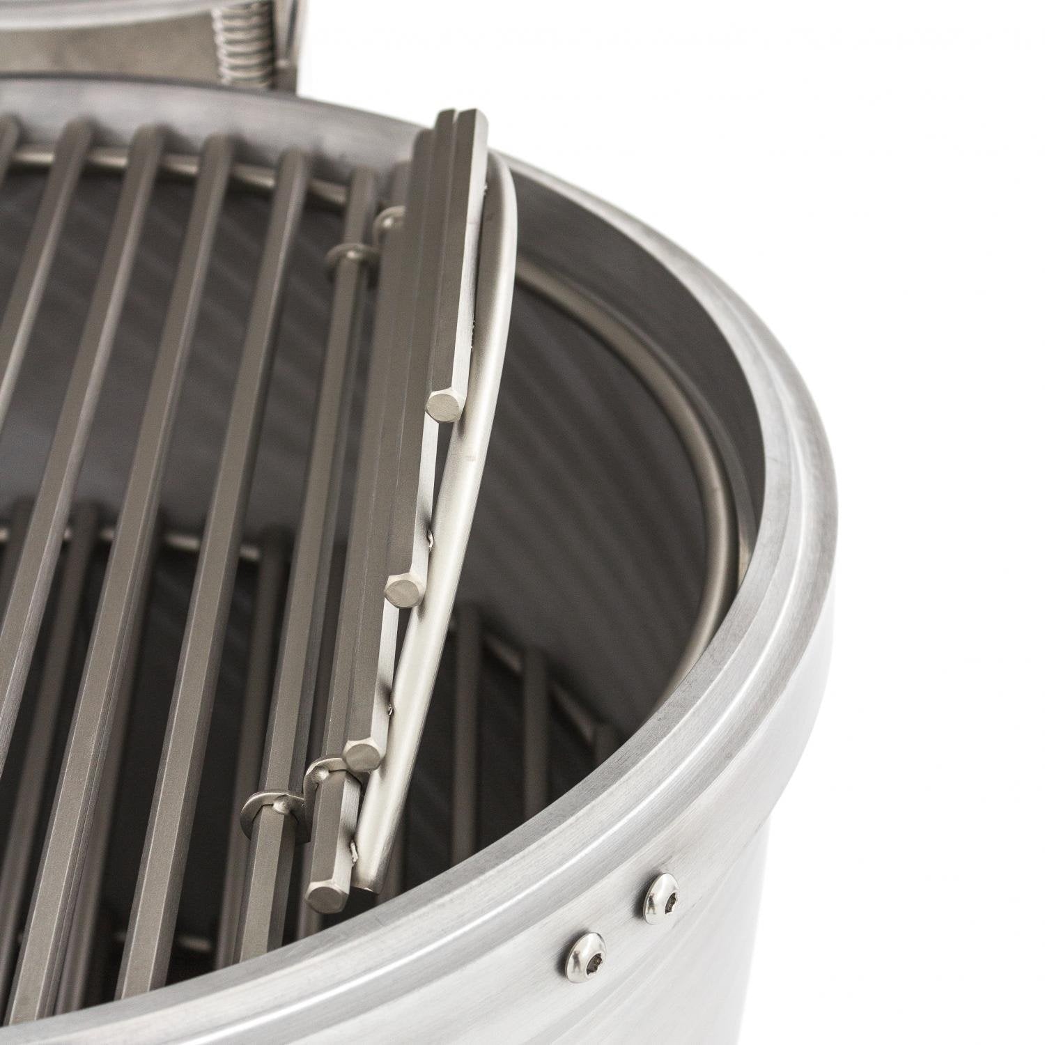 Close-up of grill side grate support bars and cast aluminum rim