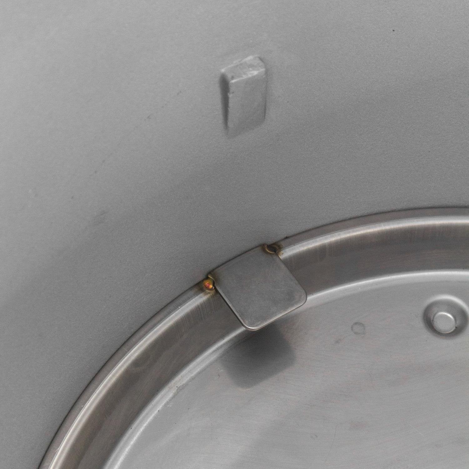 Cast aluminum kamado grill lid latch tab on curved firebox rim