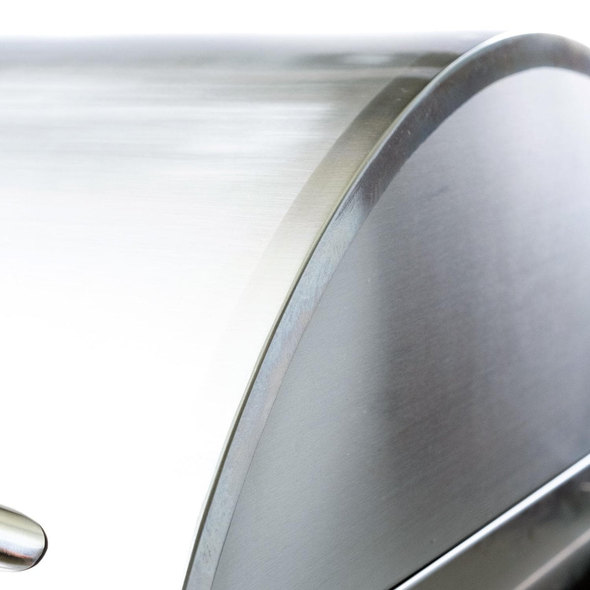 Electric grill lid edge and stainless handle curve with smooth metal finish