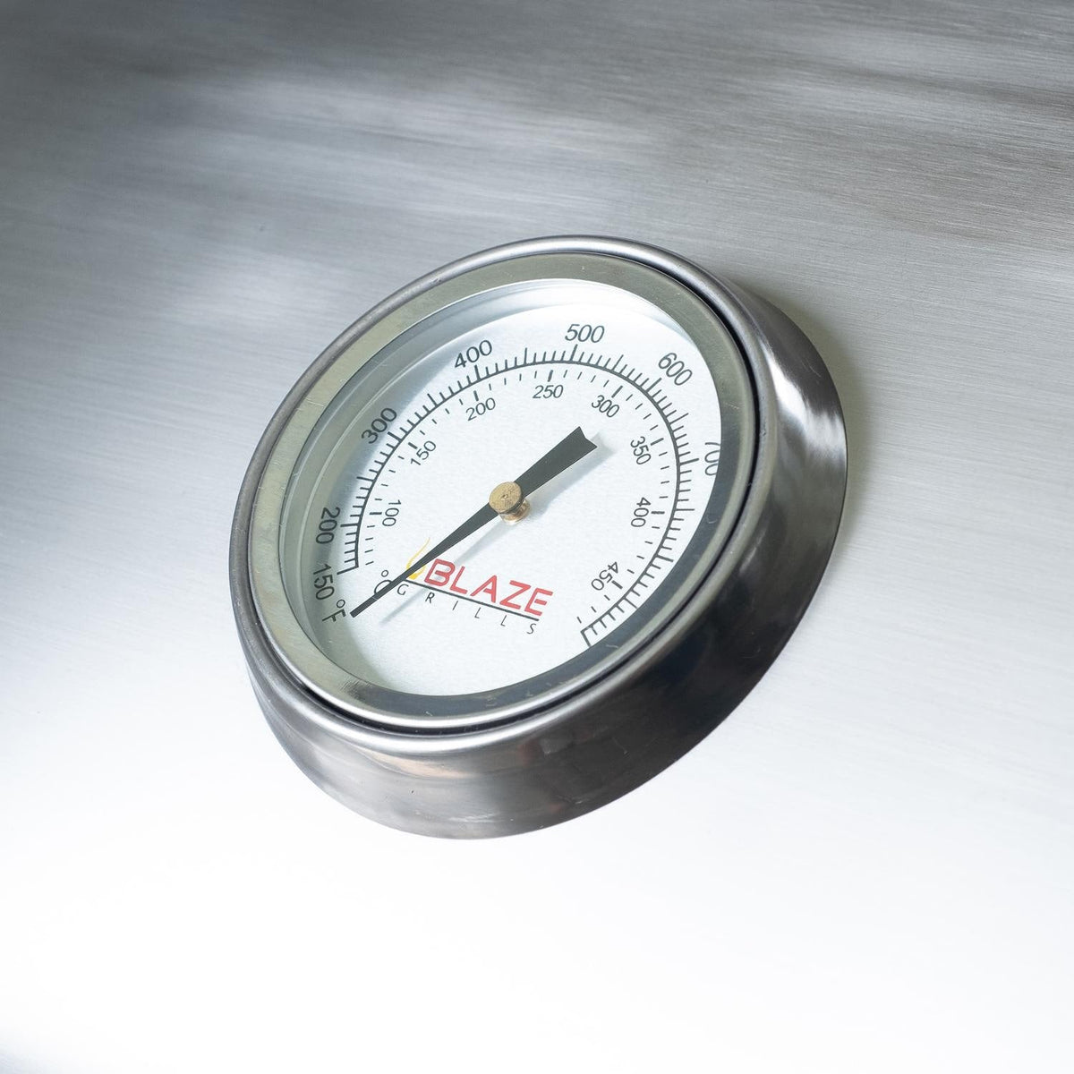 Electric grill temperature gauge with dial face and needle on stainless panel