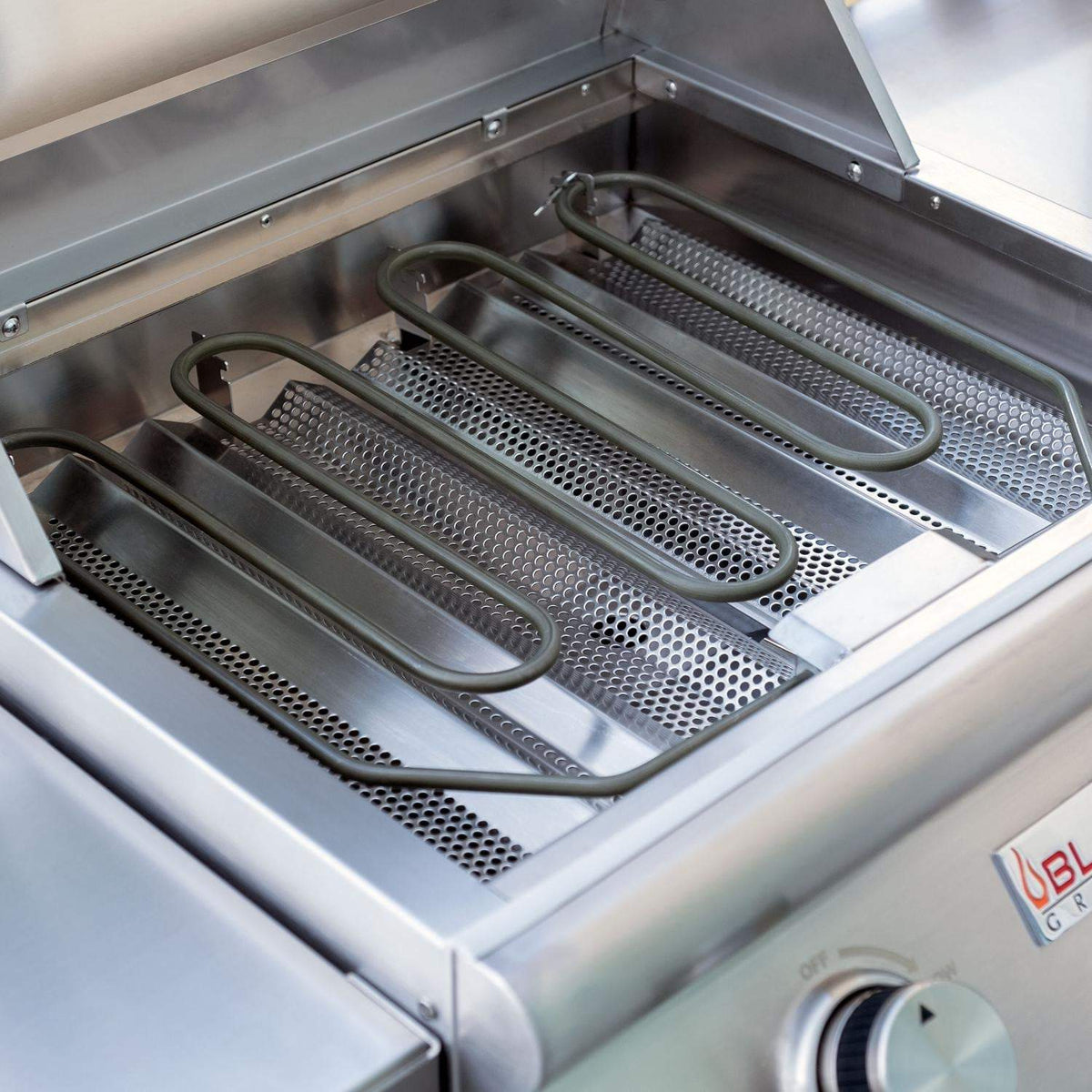 Open electric grill with stainless cooking grates and drip tray inside