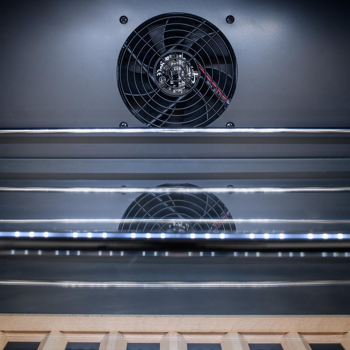 Stainless steel grill cavity with top and middle fan vents and airflow housings