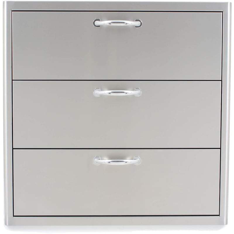 Three-drawer front with chrome pull handles on a brushed steel panel