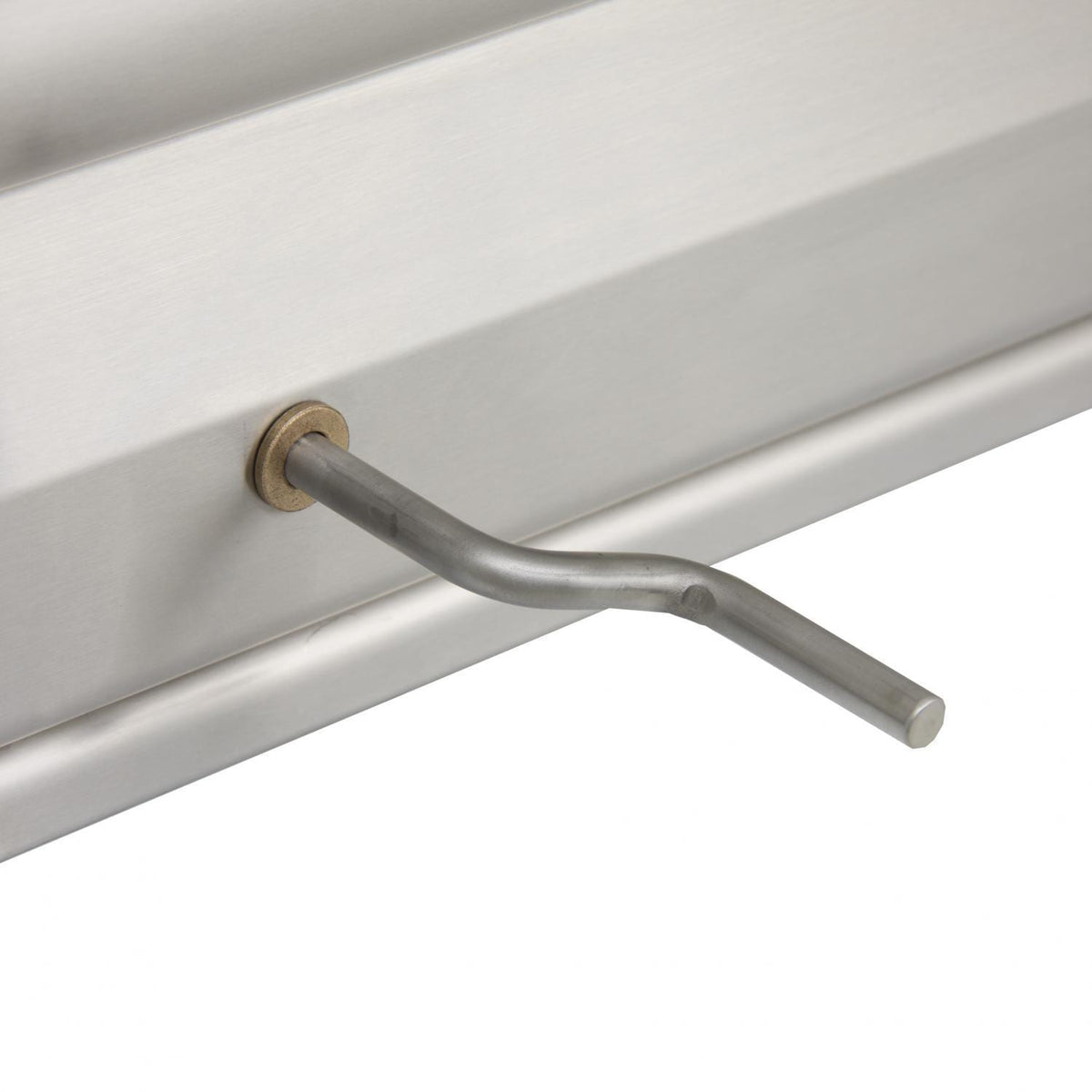 Stainless side handle with brass-toned end cap on charcoal grill