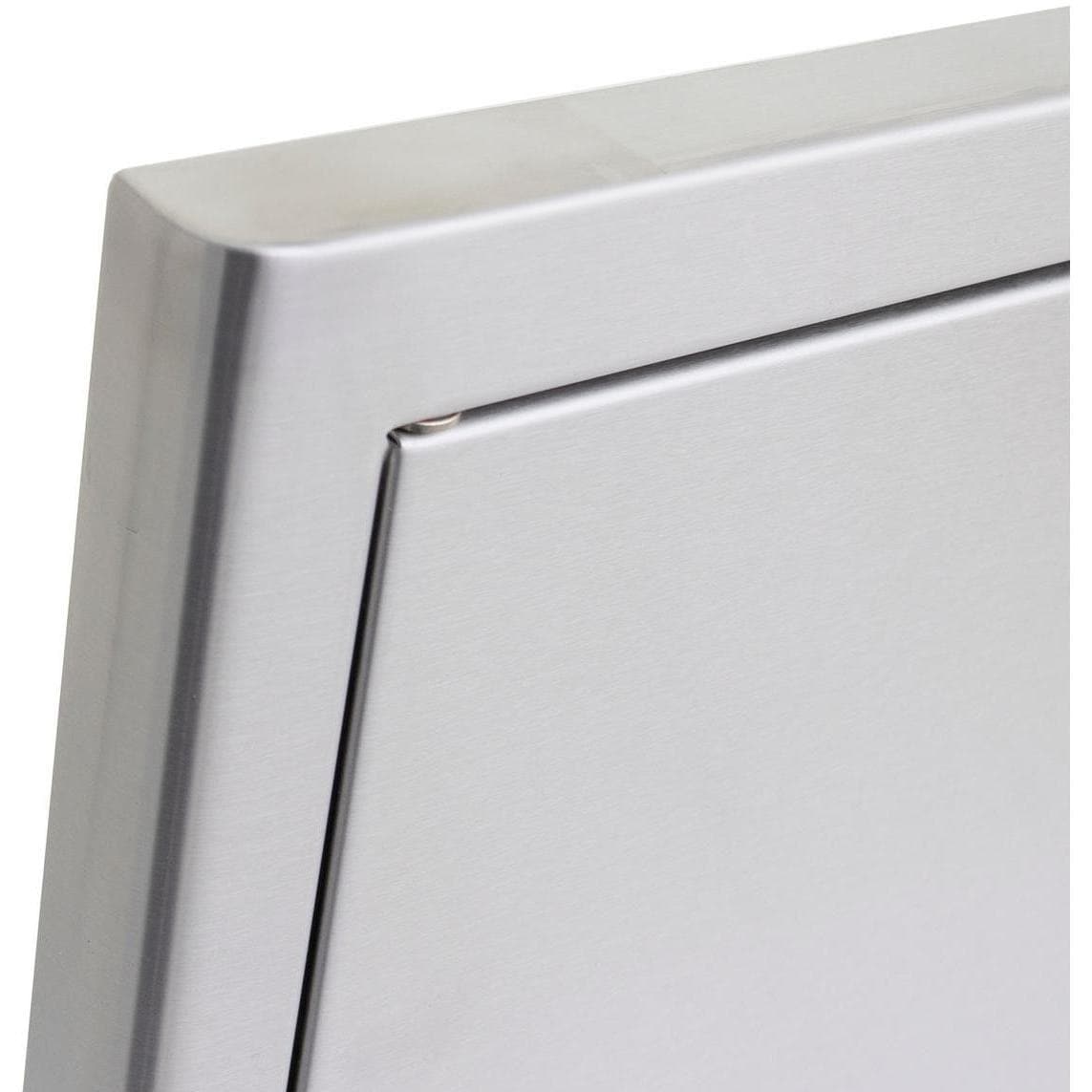 Stainless steel door corner with smooth edge and recessed frame detail