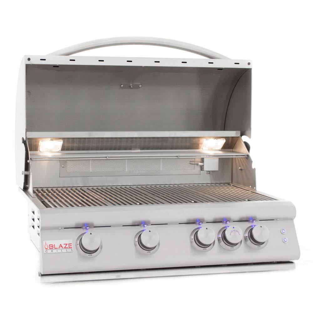 Open stainless steel grill lid with blue LED control knobs and burner area