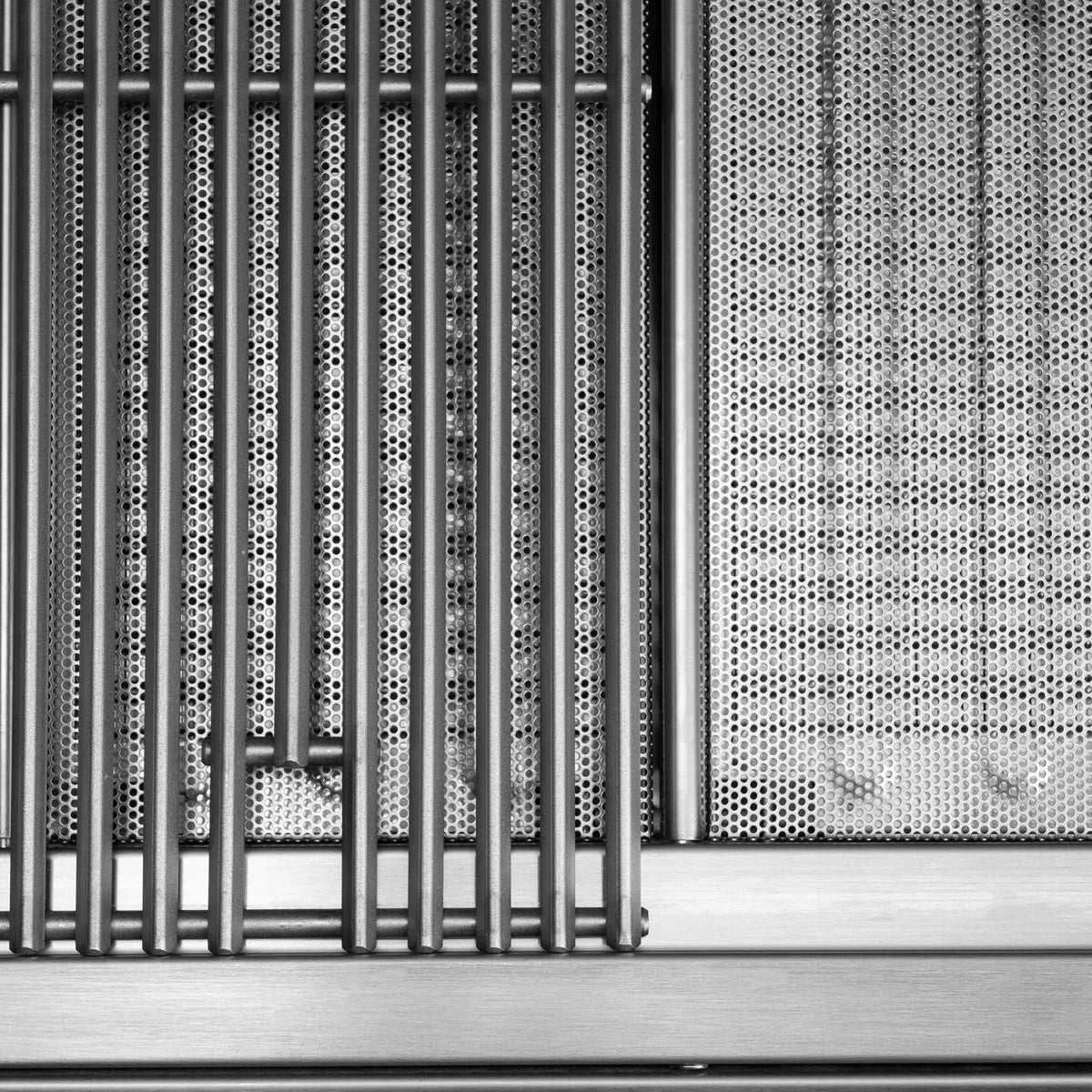 Perforated stainless steel flame tamer grid with aligned rows of small circular holes