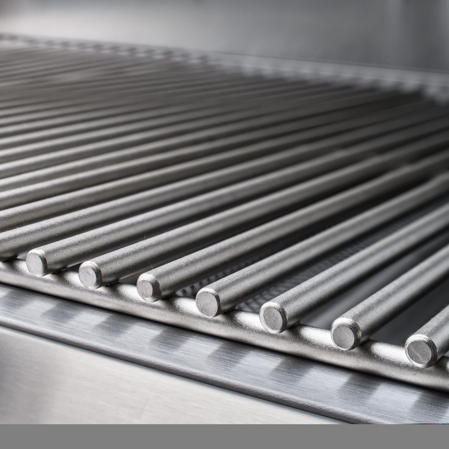 Stainless steel grill burner tubes and metal heat shield inside the 4-burner grill