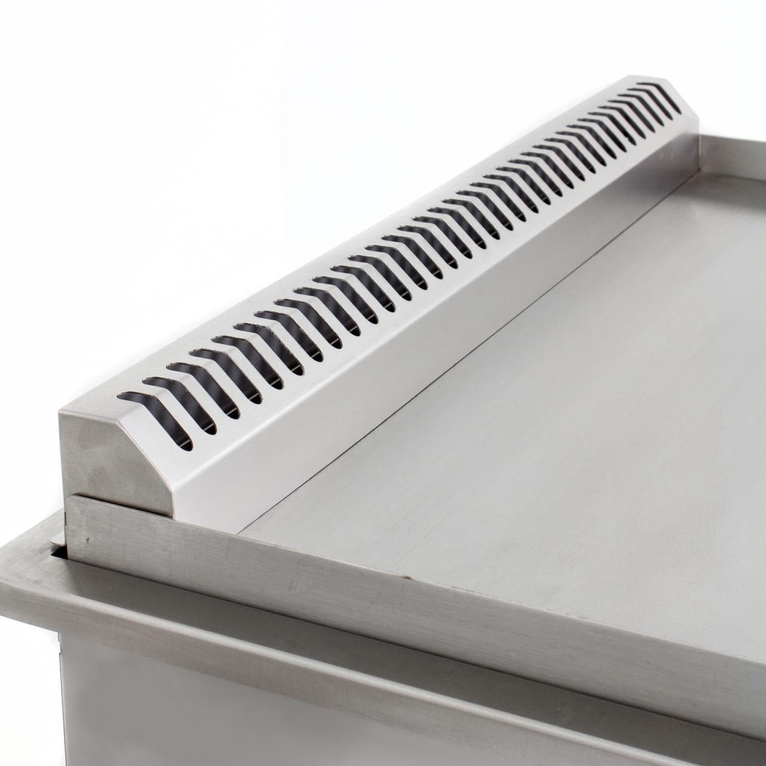 Stainless burner cover with vented slots on top of griddle
