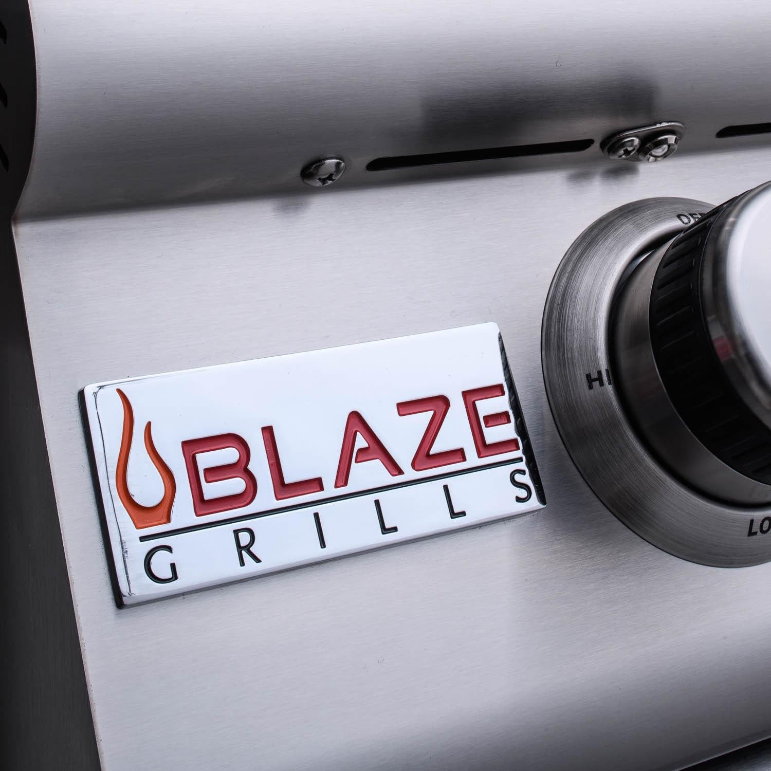 Stainless grill control label 'BLAZE GRILLS' with burner knob below