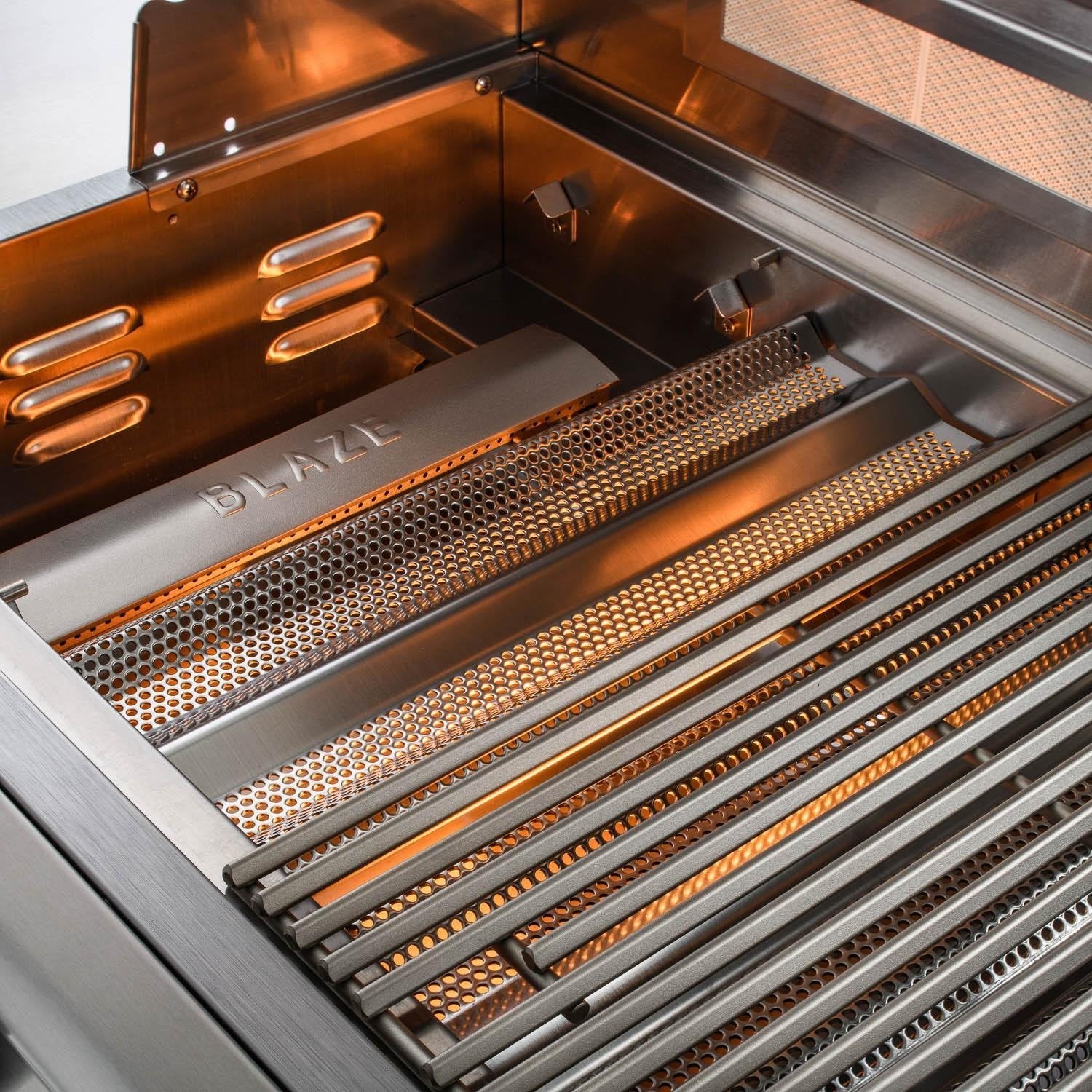 Open stainless steel grill with illuminated flavor bars and perforated cooking grates