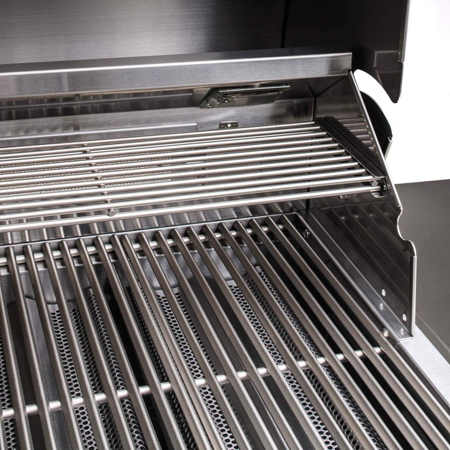 Stainless steel grill grates with warming bars inside open hood
