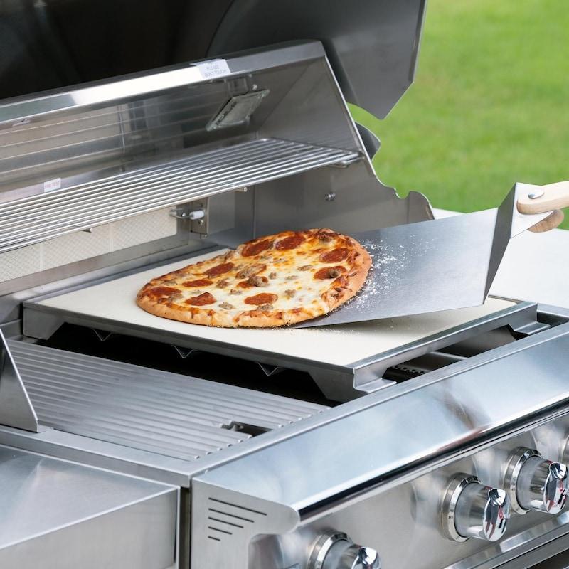 Ceramic pizza stone with stainless steel tray, holding a baked pizza