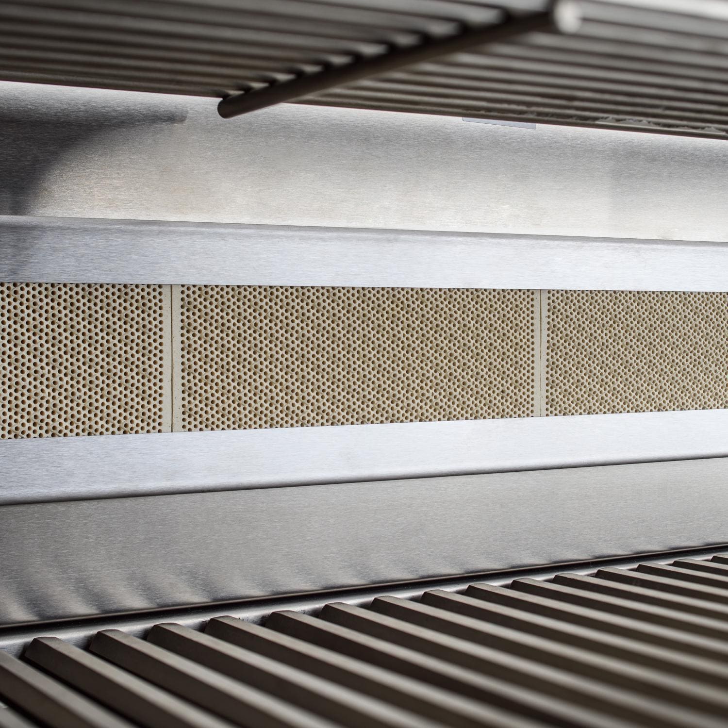Built-in stainless steel grill interior with burner grates and heat shields
