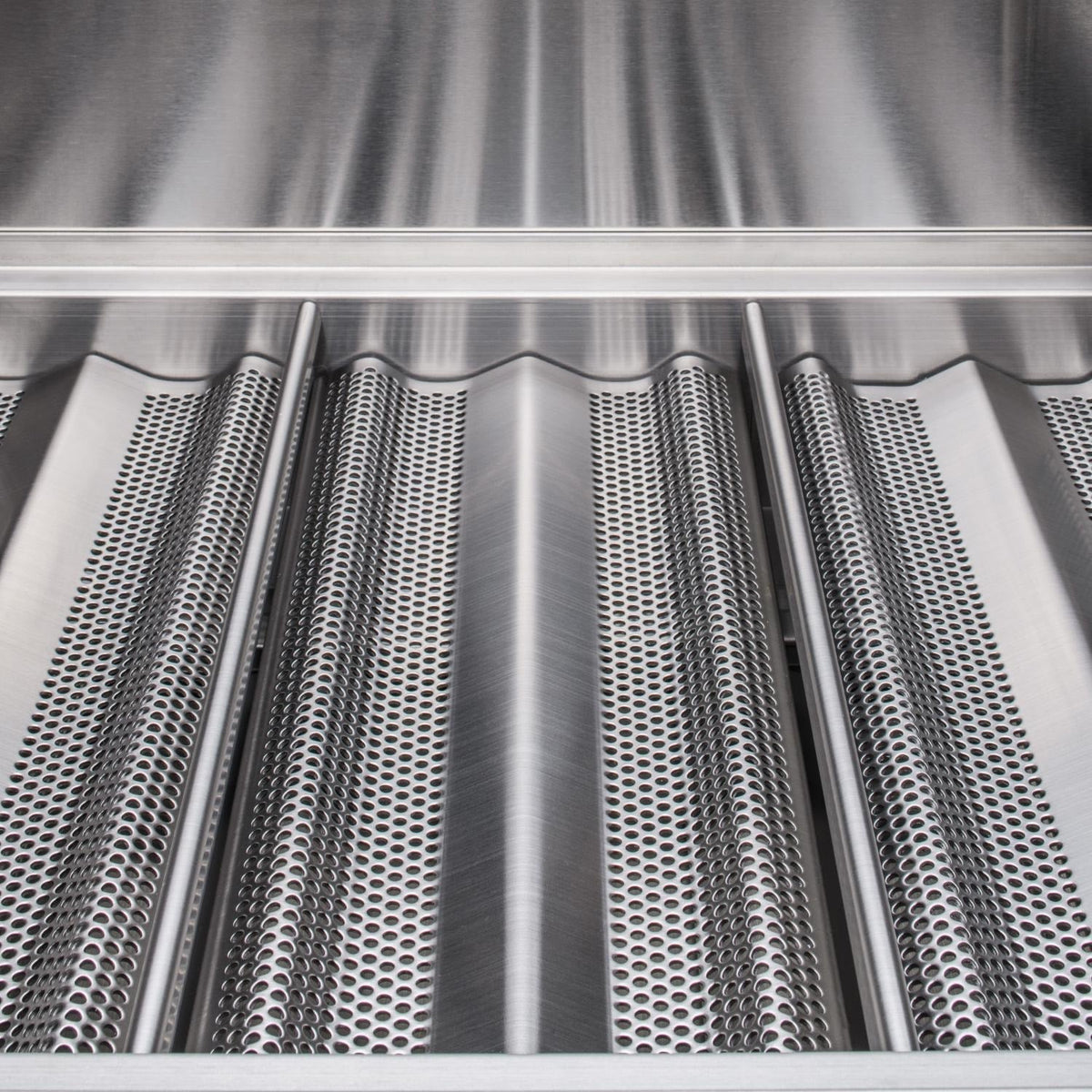 Close-up of stainless steel cooking grate with cylindrical heat shields