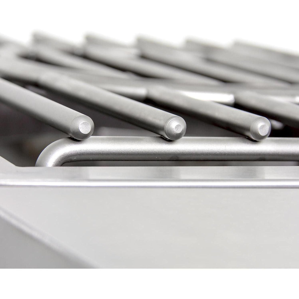 Close-up of stainless grill grates with parallel metal bars and burner openings