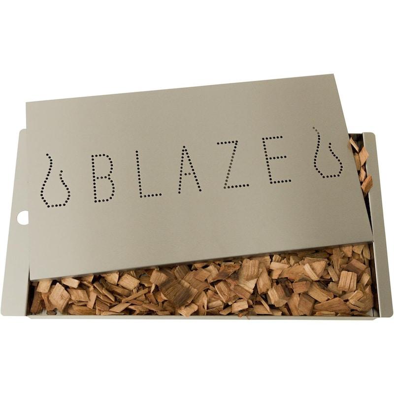 Stainless steel smoker box with perforated BLAZE logo panel and visible wood chips