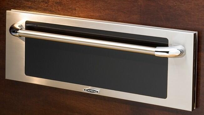 Stainless warming drawer with black front panel and long curved bar handle