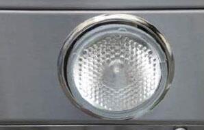 Circular halogen light lens on stainless steel wall hood