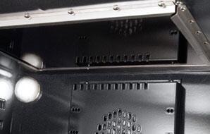Open oven cavity with black broiler cover and vented metal panel