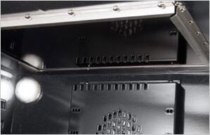 Oven interior with metal burner shield and ventilation holes