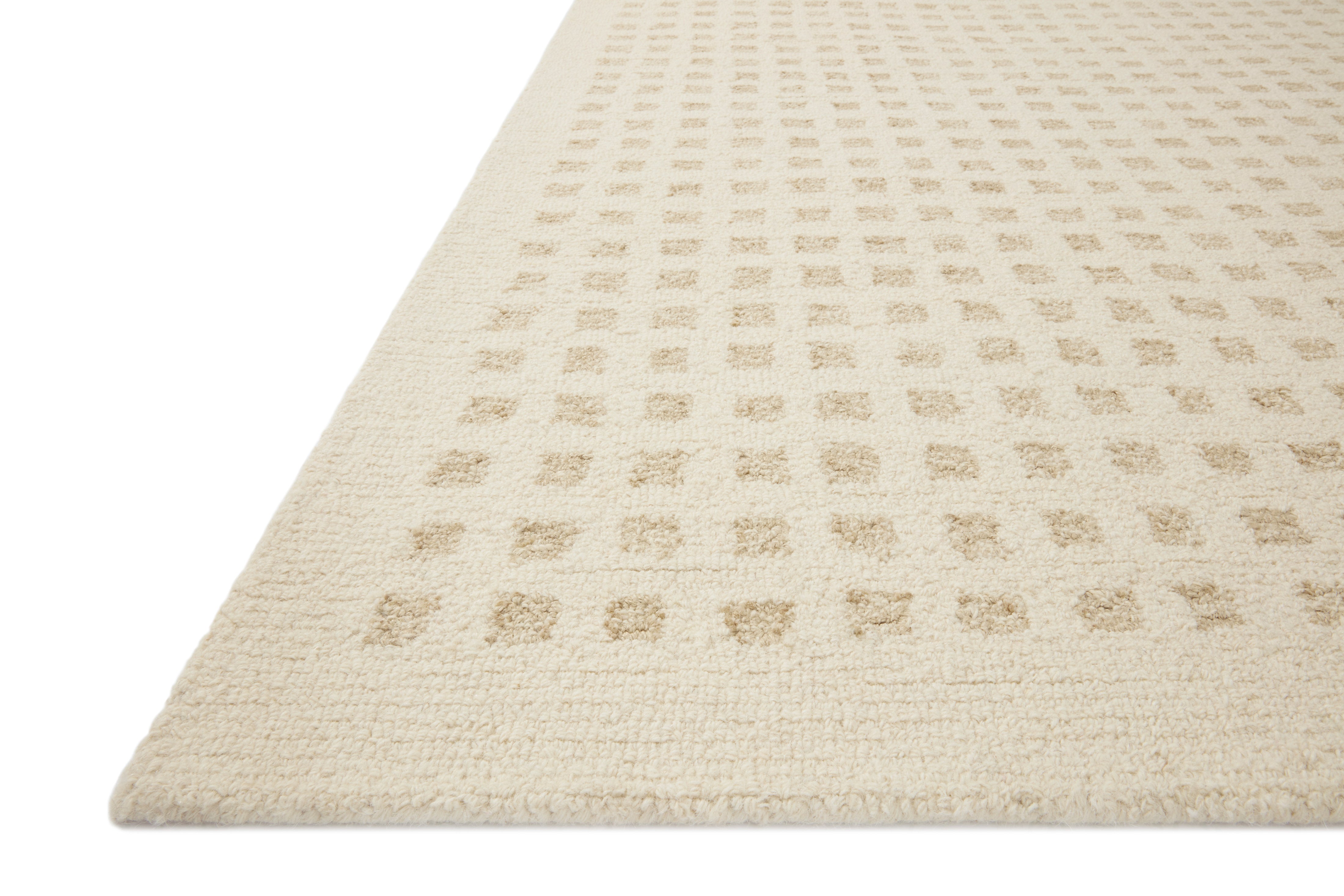 Ivory hand-tufted rug with repeating geometric grid pattern, angled
