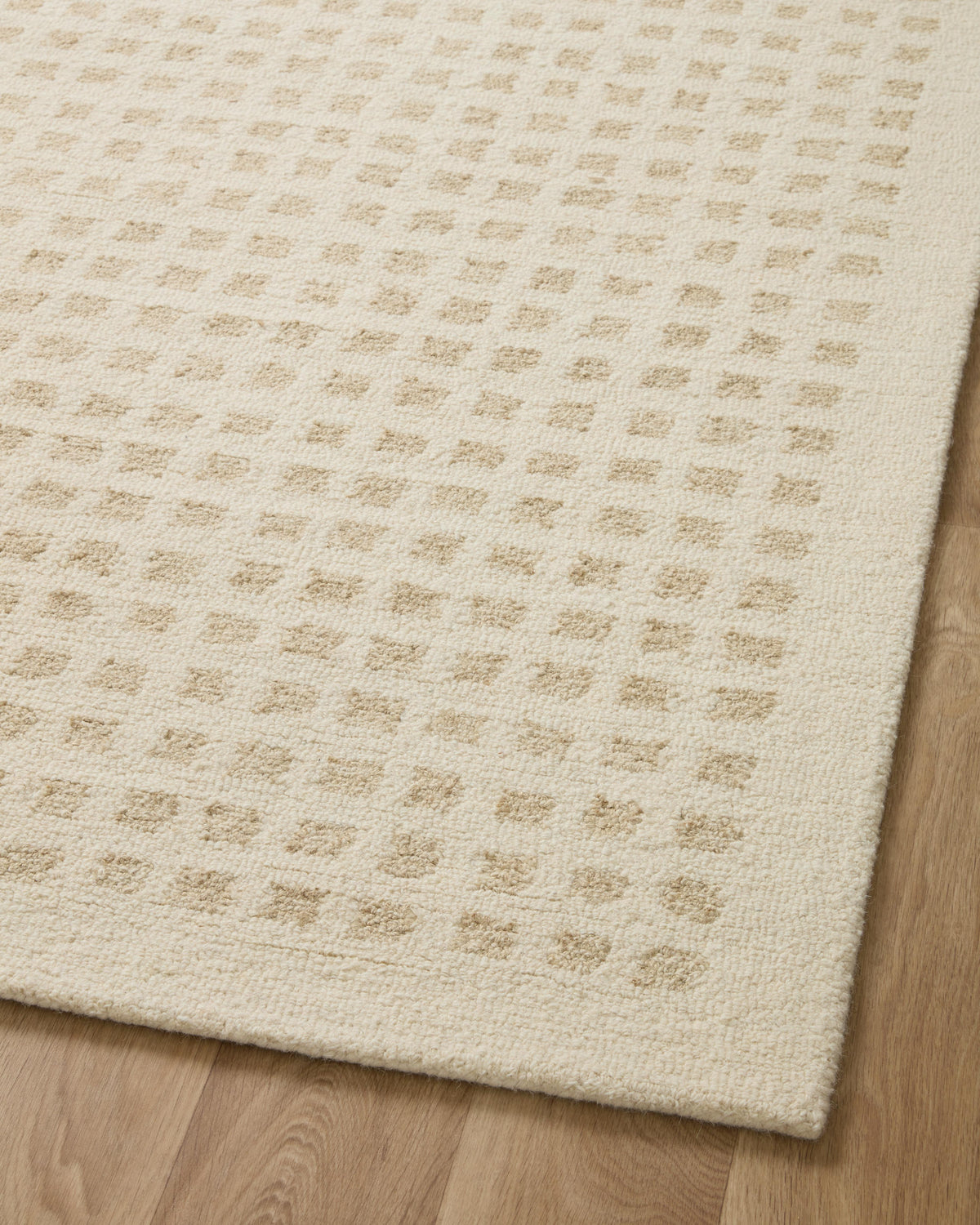 Ivory hand-tufted rug close-up with raised geometric grid motif