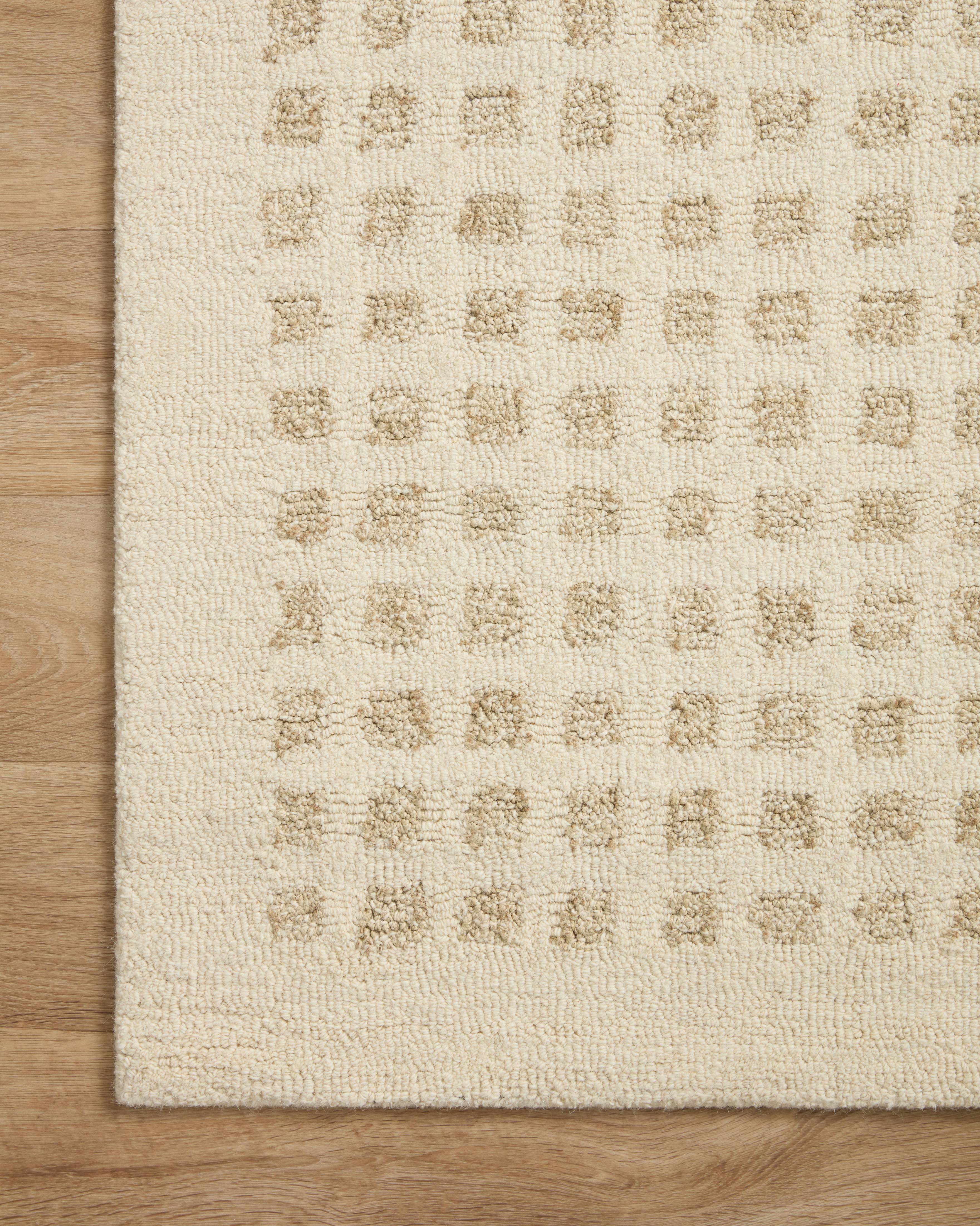 Ivory hand-tufted rug surface detail with raised geometric grid pattern