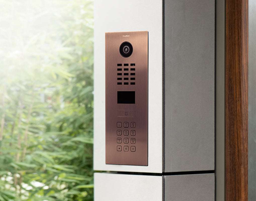 Bronze IP video door intercom with camera lens, speaker grille, and call screen