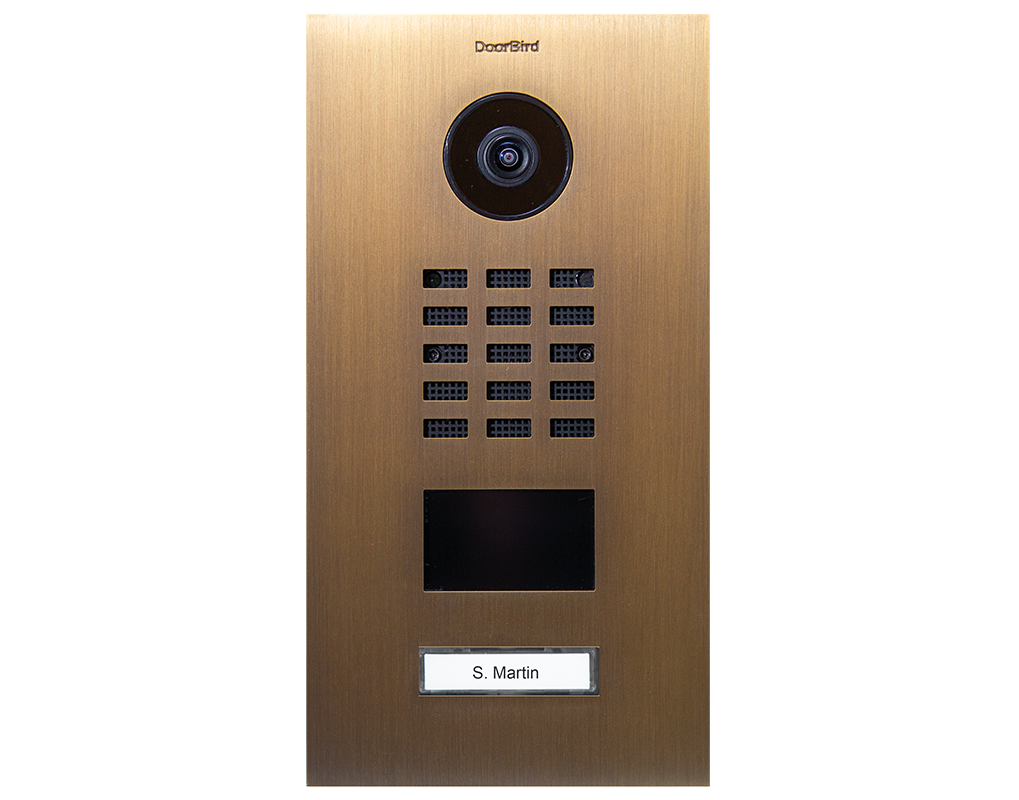 Burnished brass video door station with camera, keypad grid, and built-in display
