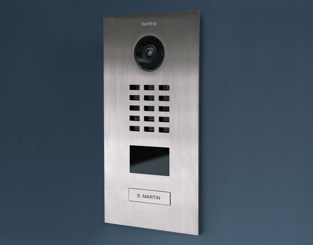 Stainless steel video door station with camera lens, keypad grid, and black display