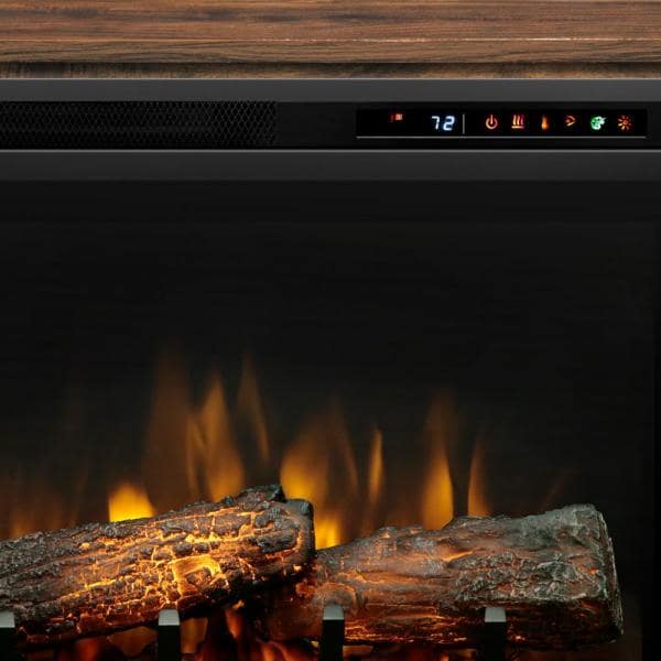 Electric fireplace logs with glowing flame effect behind dark glass