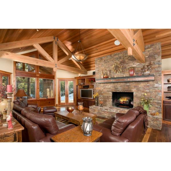 Electric fireplace with faux log set and amber flame glow in stone surround