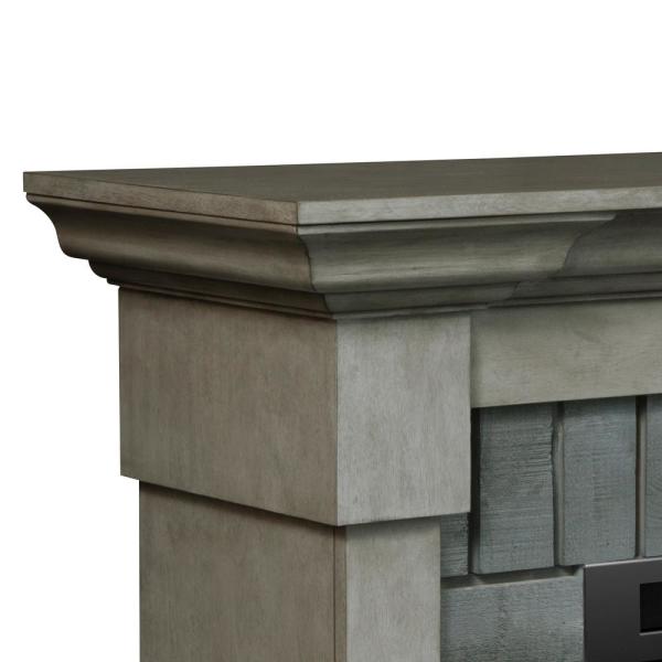 Grey stone mantel top with stepped trim and matching side pillar panels