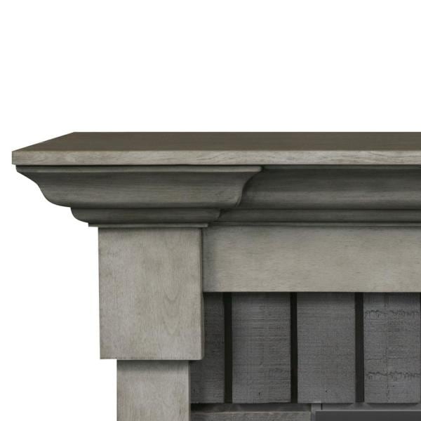 Grey stone mantel corner with vertical paneling and stepped top ledge