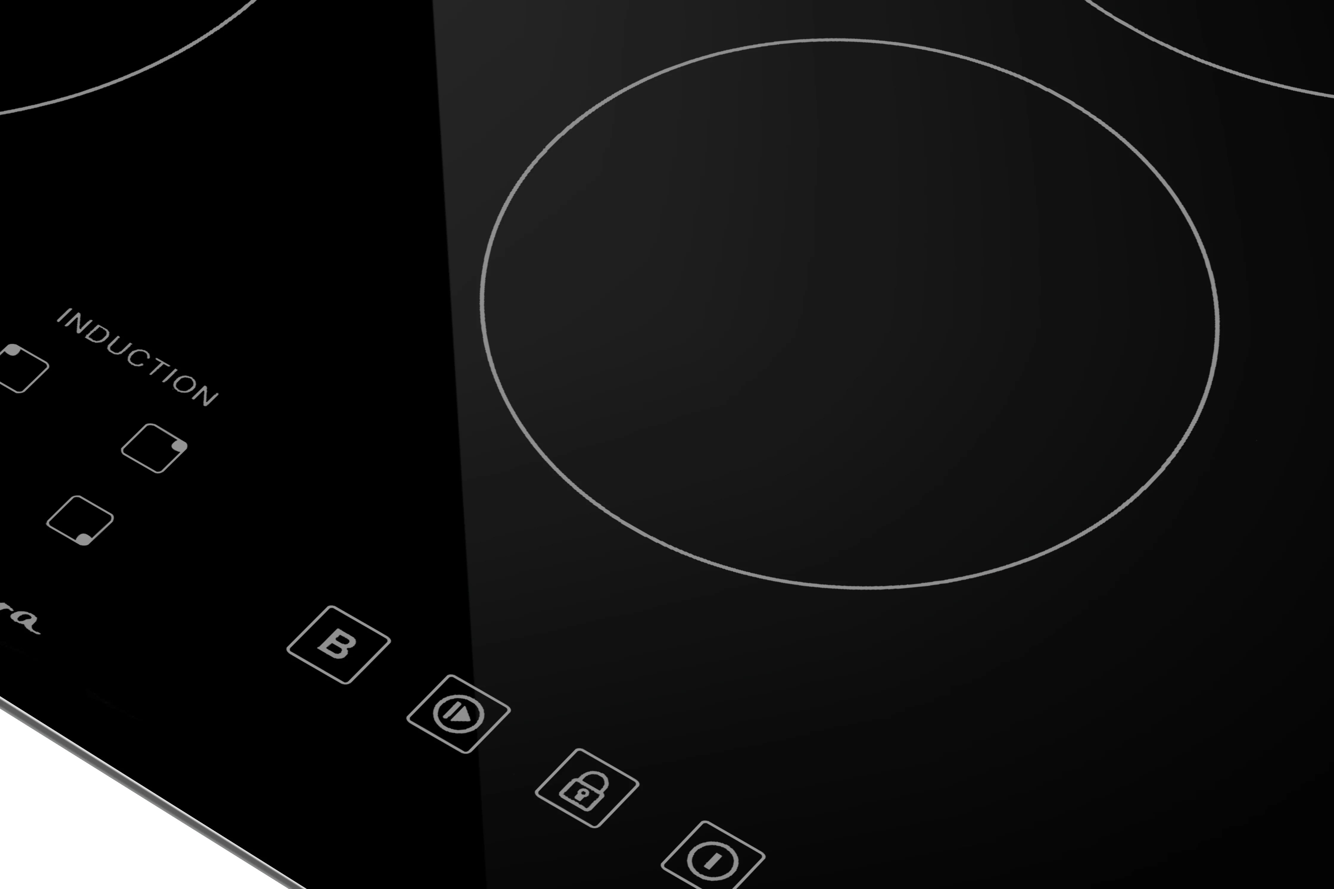 Close-up of large round heating element on a black induction cooktop