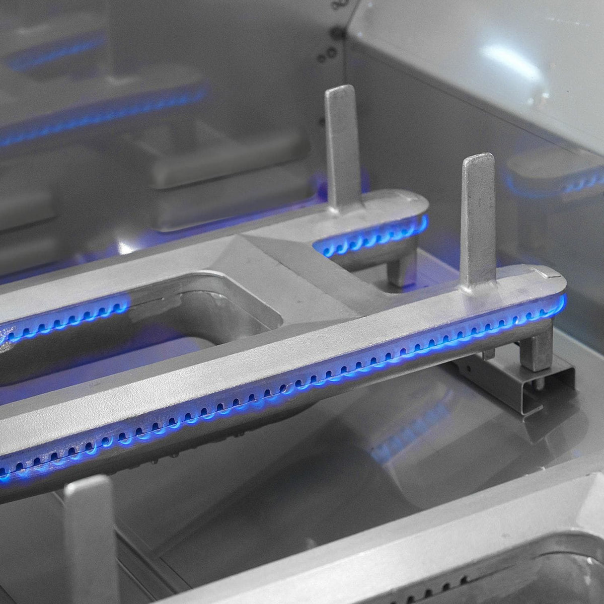 Infrared burner area inside grill with blue heating elements glowing