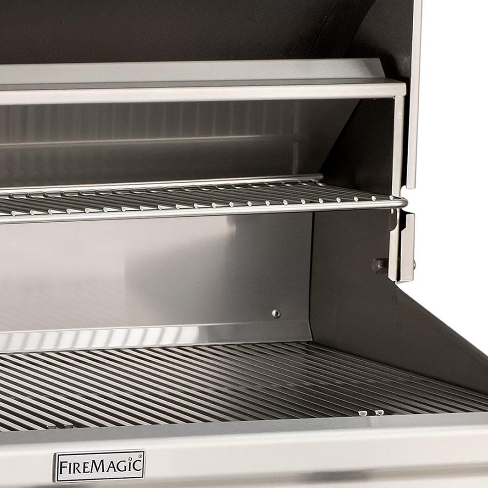 Built-in natural gas grill interior with grates and FireMagic logo