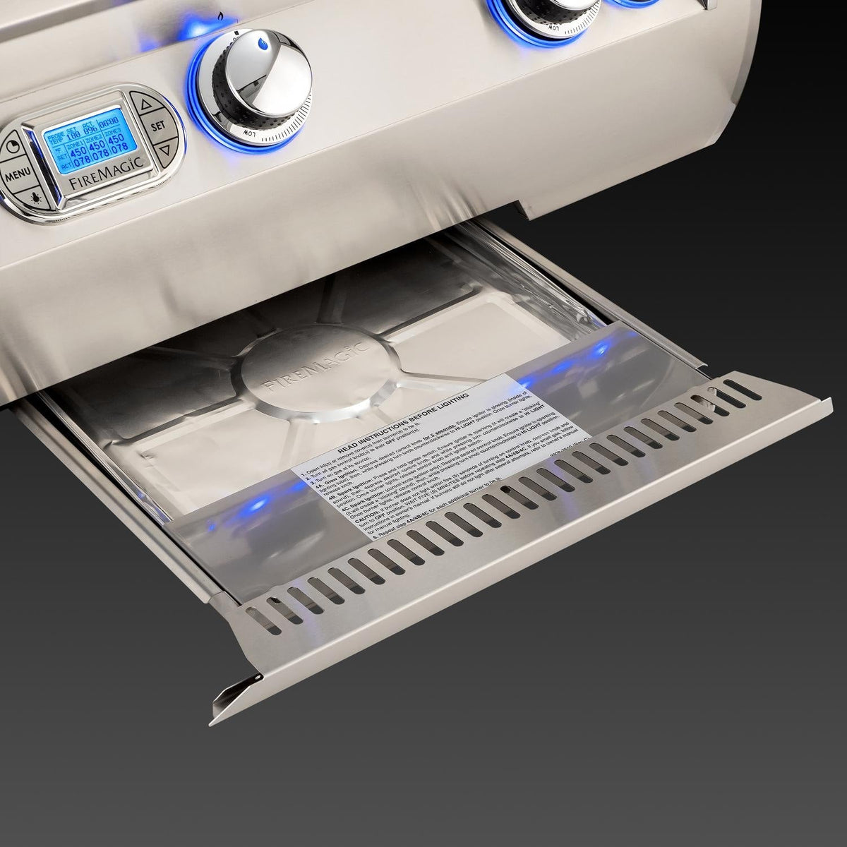 Pull-out drip tray inside stainless grill with blue indicator lighting and vents