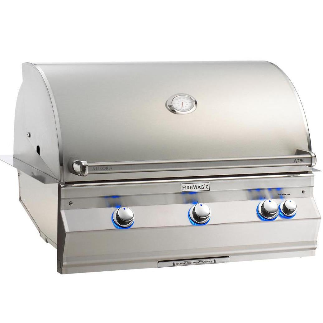 Fire Magic built-in gas grill with analog thermometer and control knobs