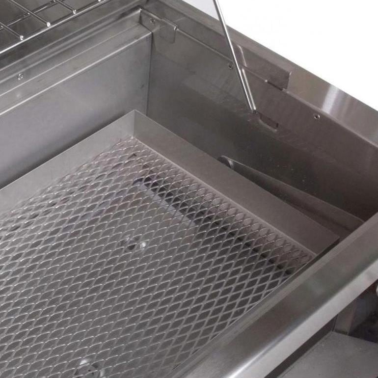 Charcoal tray with metal grate inside the grill firebox