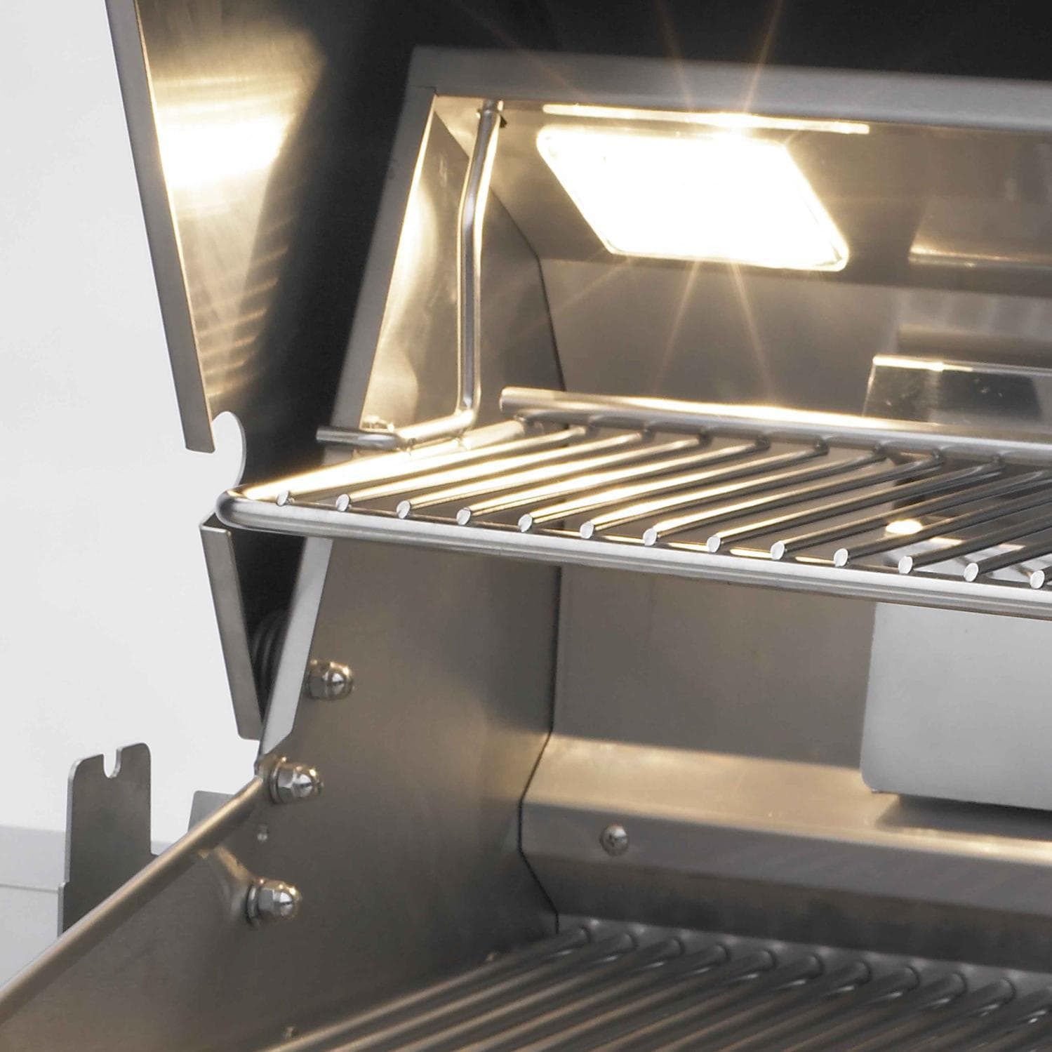 Open stainless steel gas grill with cooking grates and interior burner tubes