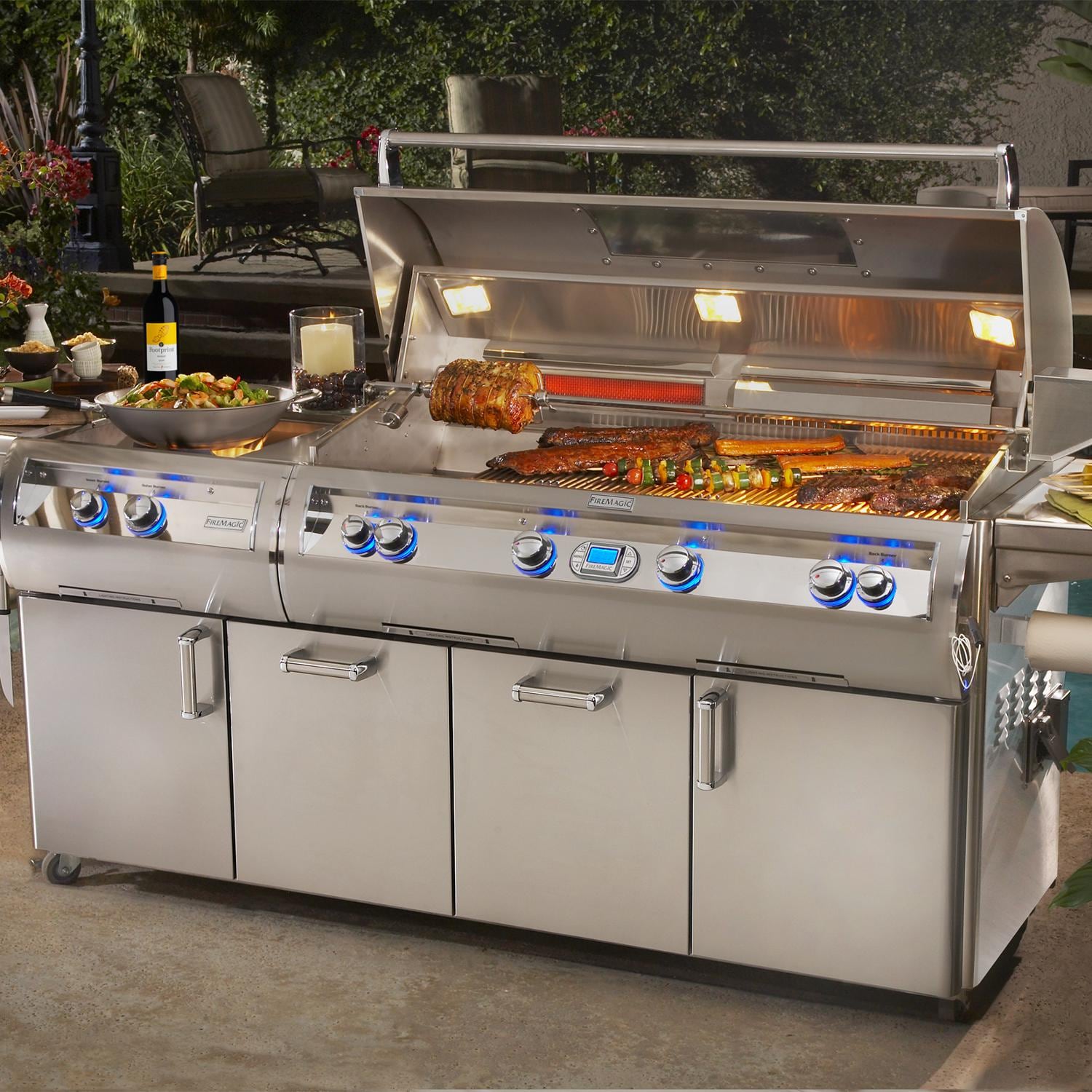 Stainless steel freestanding propane gas grill with open lid and lit burner bars