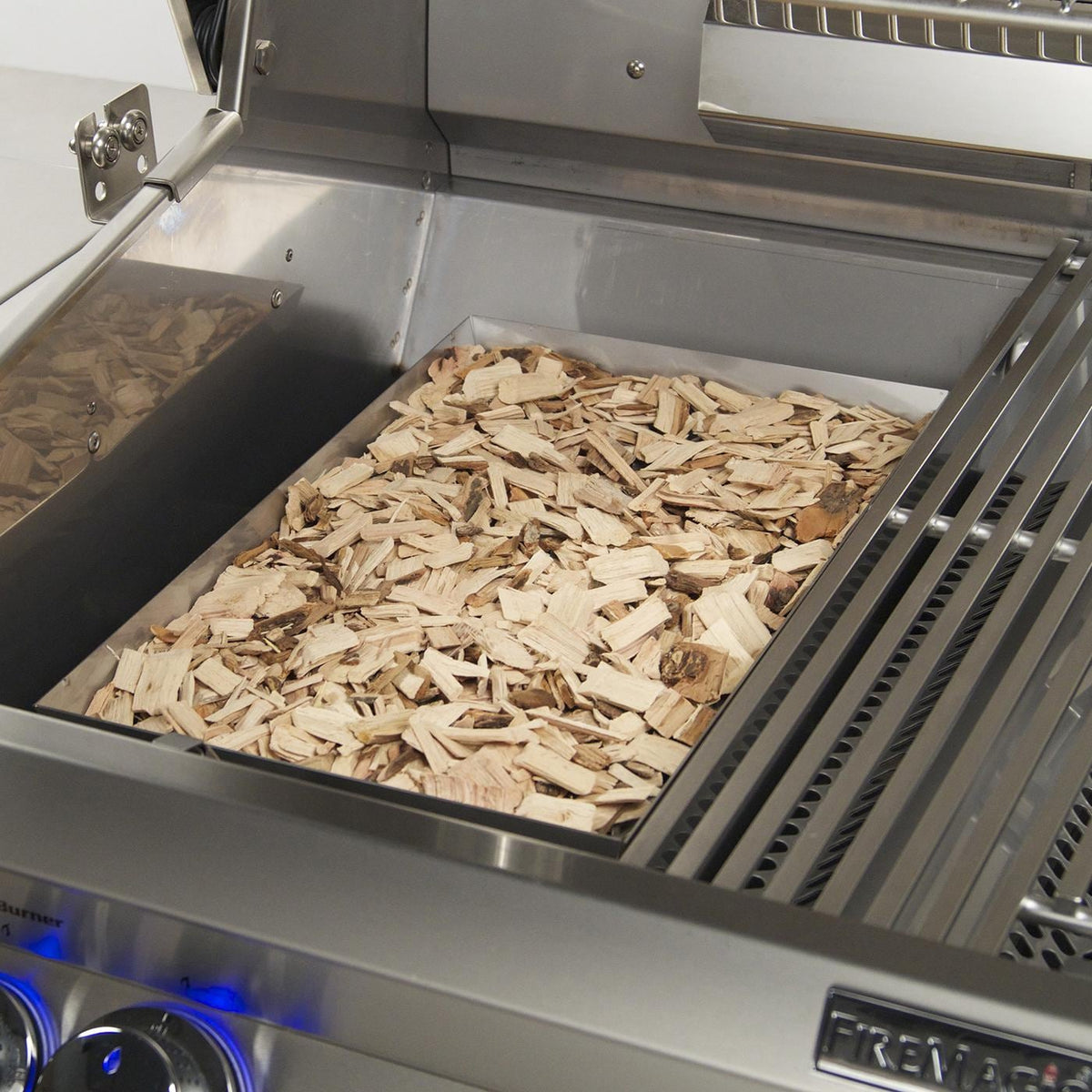 Stainless steel grill firebox filled with wood chips and metal warming grates
