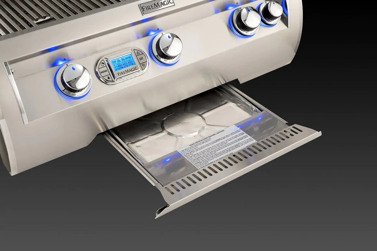 Open warming compartment drawer with lit burners and control panel above